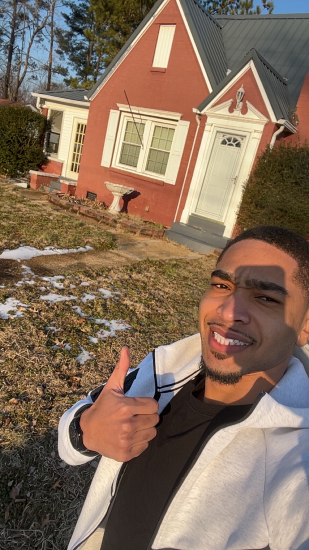 Jayden Kendall in front of a brick Tennessee home