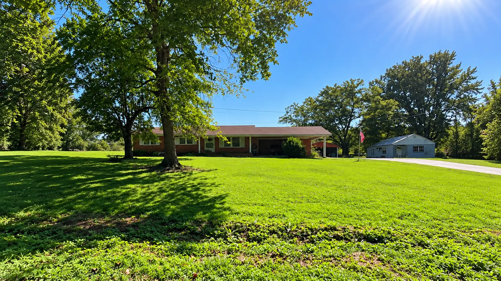 Brick Tennessee home with a broad green lawn and outbuilding